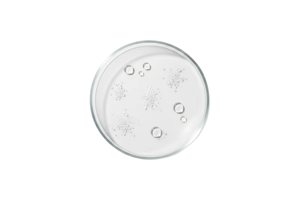 Top-down laboratory photography of a clear glass petri dish on a pure white background.
Inside the petri dish is panthenol represented as clear, translucent gel droplets or fine crystalline powder,
arranged neatly and minimal.
Clinical, dermatology-inspired aesthetic.
Soft, diffused studio lighting.
Ultra-clean, high detail, realistic texture.
Pure white background, no gradients, no shadows.
No text, no labels, no branding.